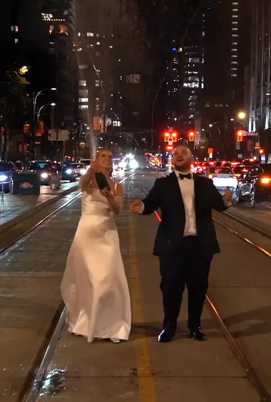 Kristina & Dan spraying champagne in the middle of Spadina Ave in Toronto.